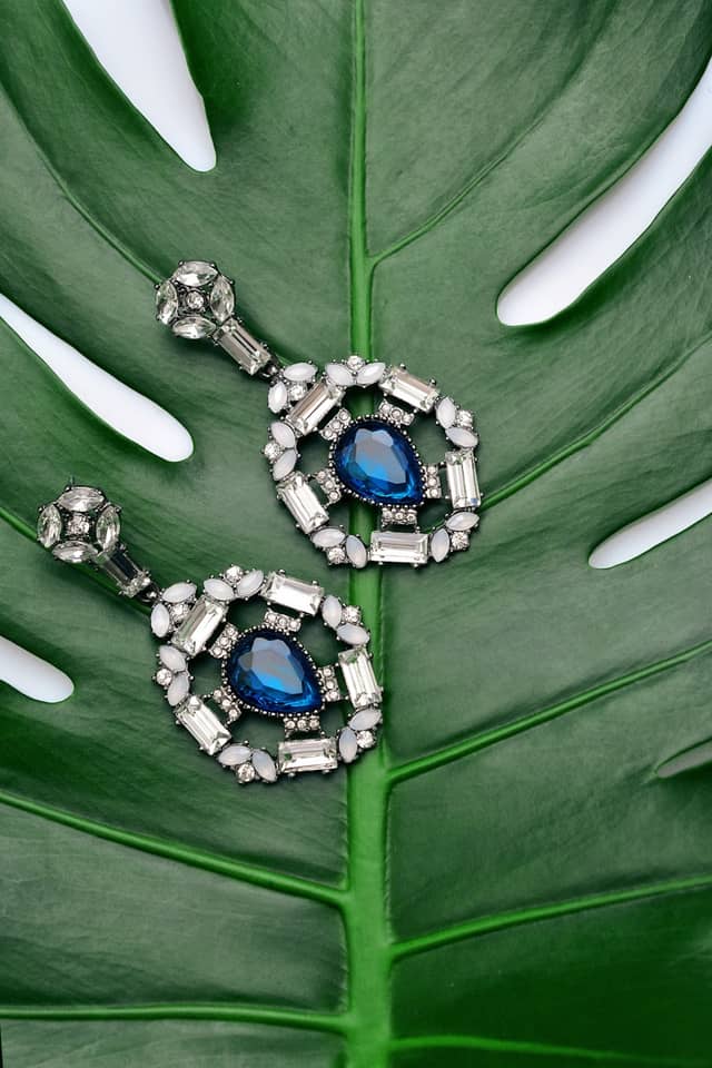 Drop earrings set with blue pear-shaped stones framed by clear baguette stones